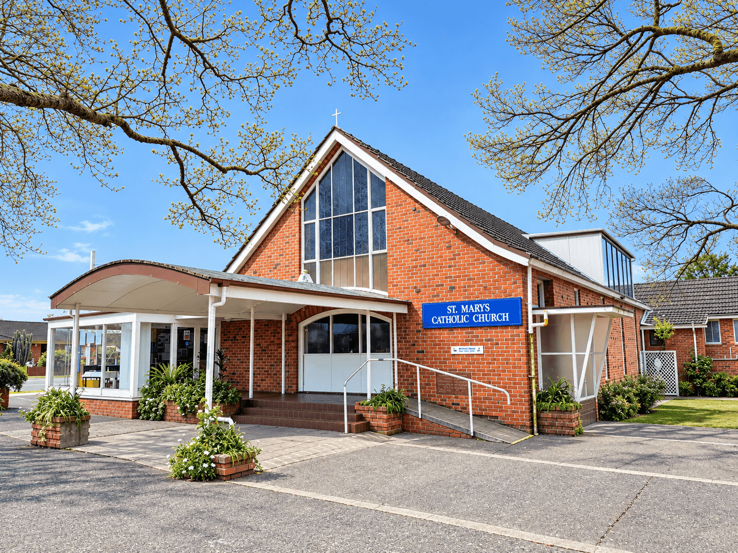 Brick front of St Mary's Catholic Church, Papakura, with its name sign above the entrance